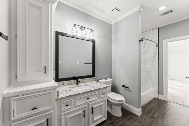 full bathroom featuring vanity, toilet, ornamental molding, and tiled shower / bath combo