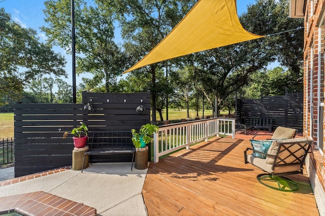 wooden terrace with an outdoor living space