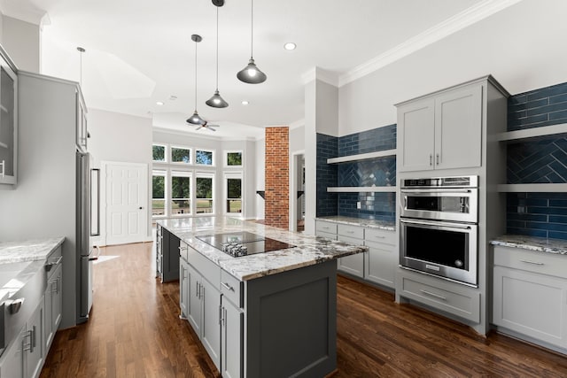 kitchen featuring backsplash, gray cabinets, and stainless steel appliances