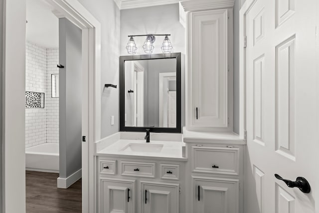 bathroom with vanity, wood-type flooring, and tiled shower / bath combo