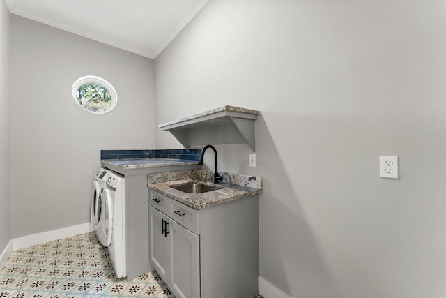 laundry room featuring cabinets, separate washer and dryer, ornamental molding, and sink