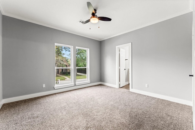 empty room with ceiling fan, crown molding, and carpet floors