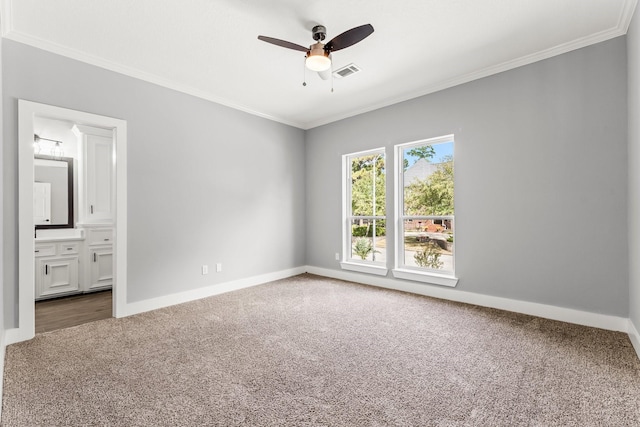 unfurnished bedroom with carpet, ceiling fan, crown molding, and ensuite bath