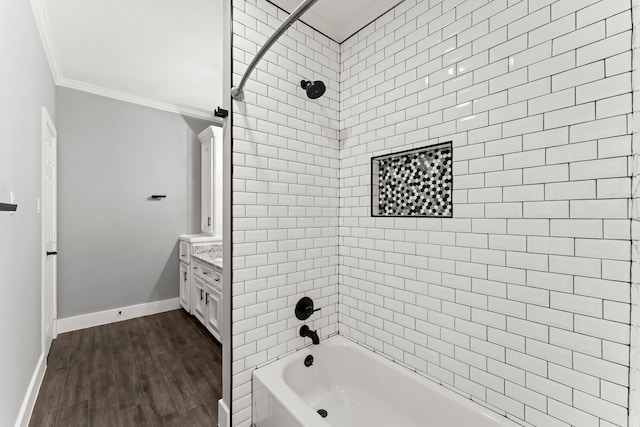 bathroom featuring vanity, ornamental molding, tiled shower / bath combo, and hardwood / wood-style flooring