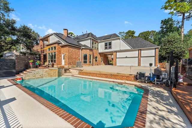 view of swimming pool with a patio area and central AC