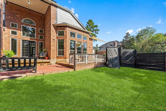 back of house with a yard and a patio