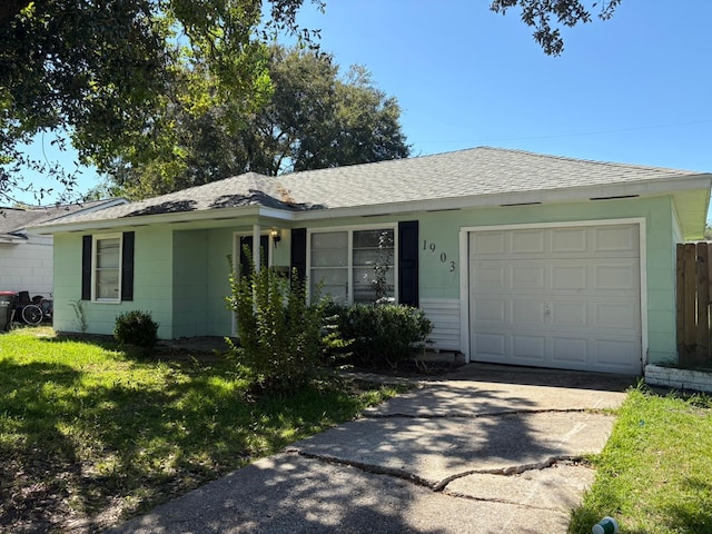 single story home featuring a front yard and a garage