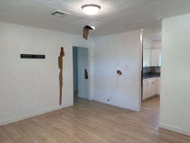 spare room with light wood-type flooring