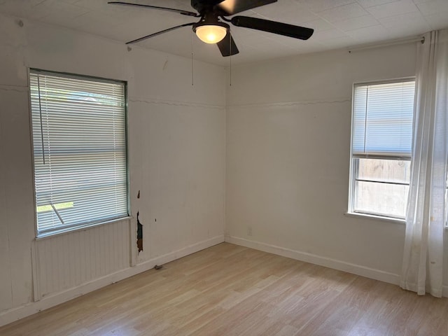 unfurnished room featuring light hardwood / wood-style floors and ceiling fan