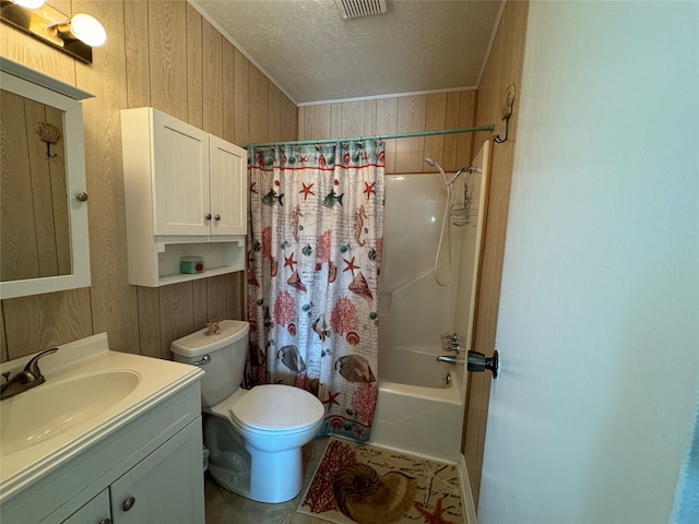 full bathroom featuring vanity, wood walls, a textured ceiling, shower / bathtub combination with curtain, and toilet