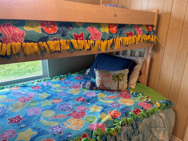 bedroom featuring wood walls