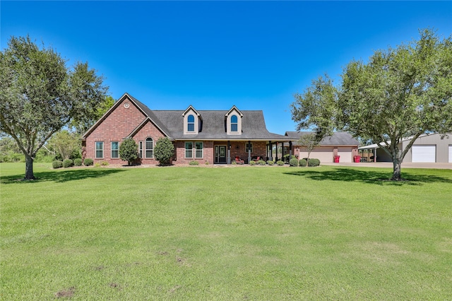 cape cod home featuring a front yard, a garage, and a porch