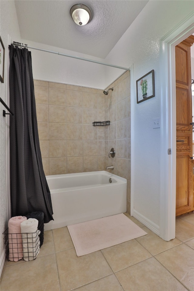 bathroom with a textured ceiling, tile patterned floors, and shower / tub combo with curtain