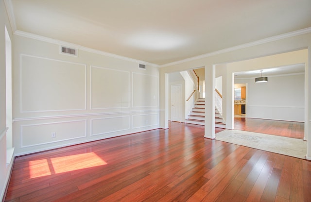 unfurnished room featuring ornamental molding and hardwood / wood-style flooring