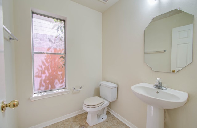 bathroom with tile patterned flooring and toilet