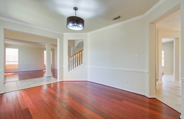 unfurnished room with wood-type flooring and crown molding