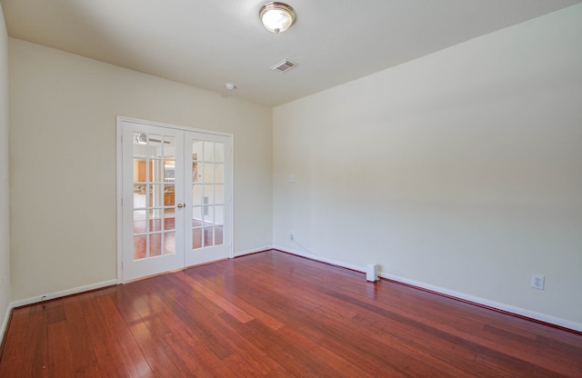 empty room with wood-type flooring and french doors