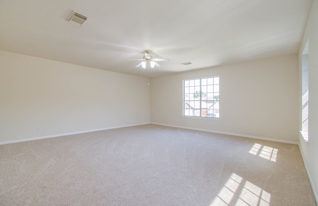 unfurnished room with ceiling fan and light carpet