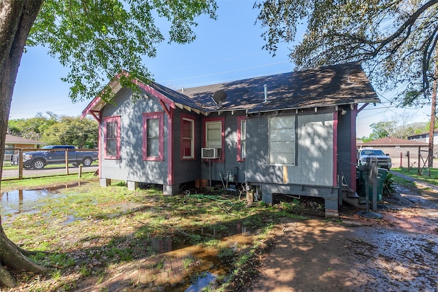 4995 Highland Ave, Beaumont, TX 77705 - view of front of home with cooling unit and roof with shingles