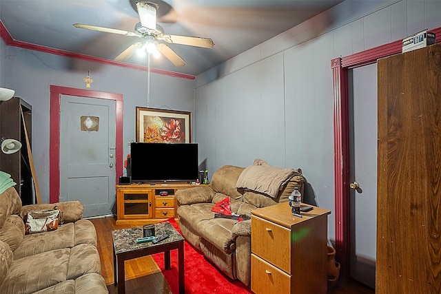 living room with ceiling fan, ornamental molding, and hardwood / wood-style floors