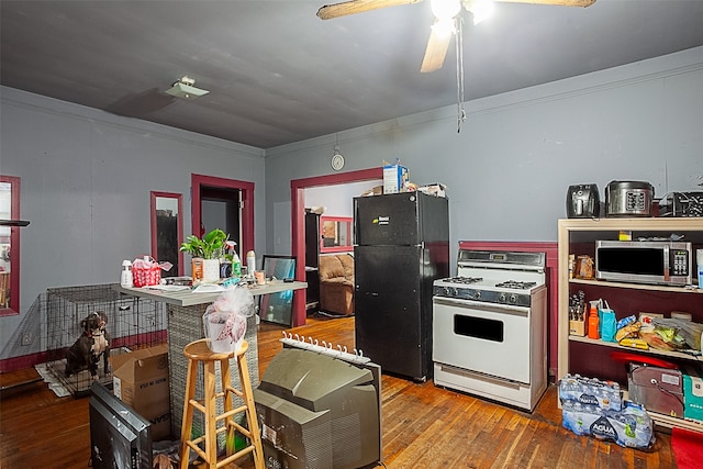 kitchen with ornamental molding, white appliances, ceiling fan, and hardwood / wood-style floors