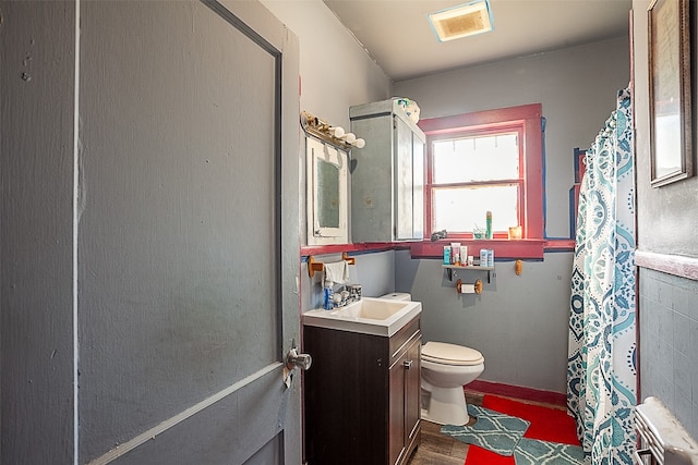 bathroom featuring vanity, toilet, and hardwood / wood-style flooring