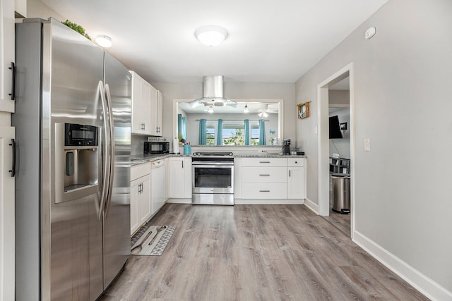 kitchen with light hardwood / wood-style flooring, white cabinetry, appliances with stainless steel finishes, and light stone countertops