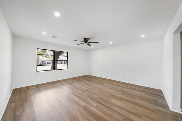 spare room with hardwood / wood-style floors and ceiling fan