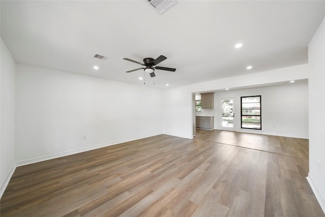 unfurnished living room featuring ceiling fan and light hardwood / wood-style floors