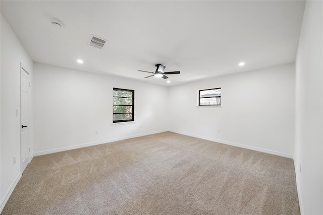 carpeted spare room with ceiling fan