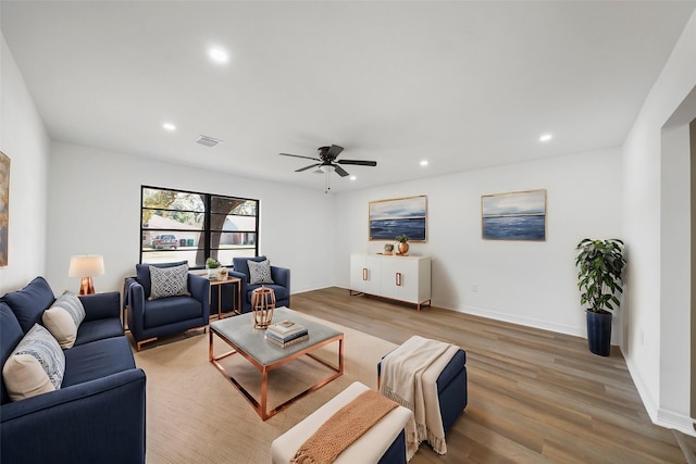 living room featuring ceiling fan and hardwood / wood-style floors