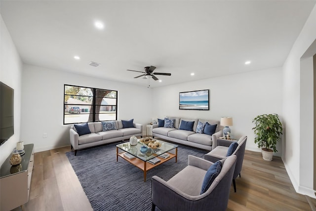 living room featuring hardwood / wood-style flooring and ceiling fan