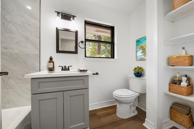 full bathroom featuring washtub / shower combination, toilet, vanity, and hardwood / wood-style flooring