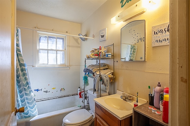 full bathroom featuring shower / bath combo, vanity, and toilet