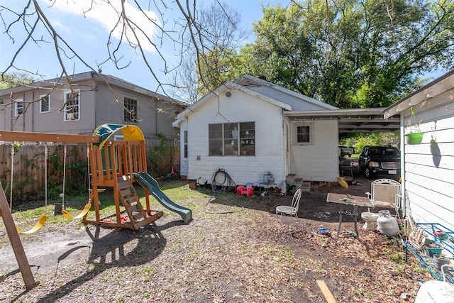 exterior space with a playground and a carport