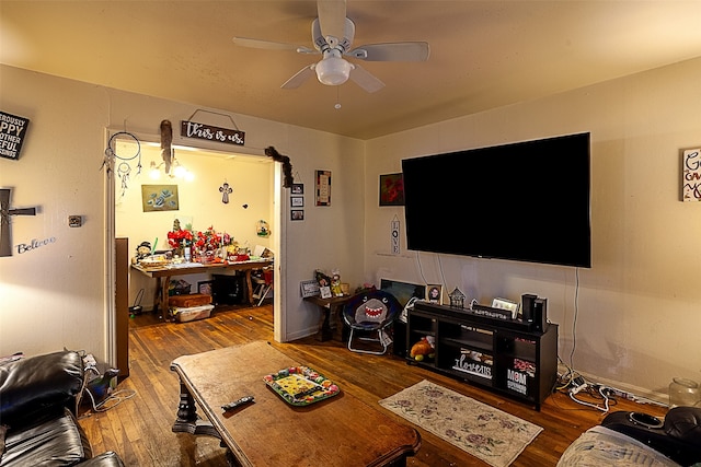 living room featuring ceiling fan and hardwood / wood-style flooring