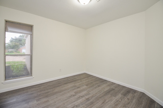 spare room with dark wood-type flooring