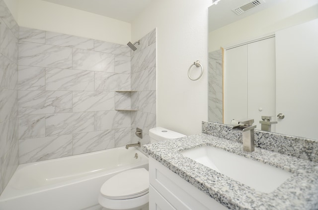 full bathroom with tiled shower / bath, vanity, and toilet