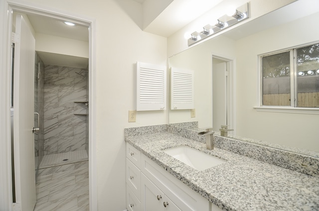 bathroom with vanity and tiled shower