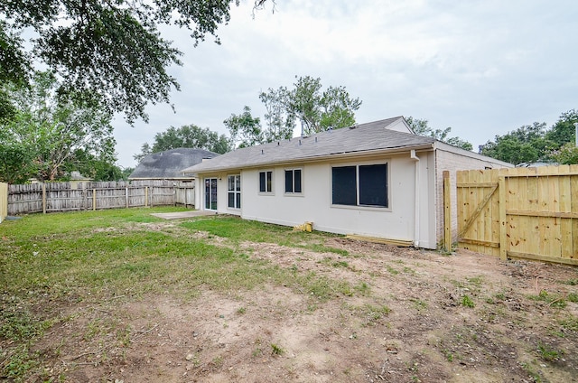 back of property featuring a yard