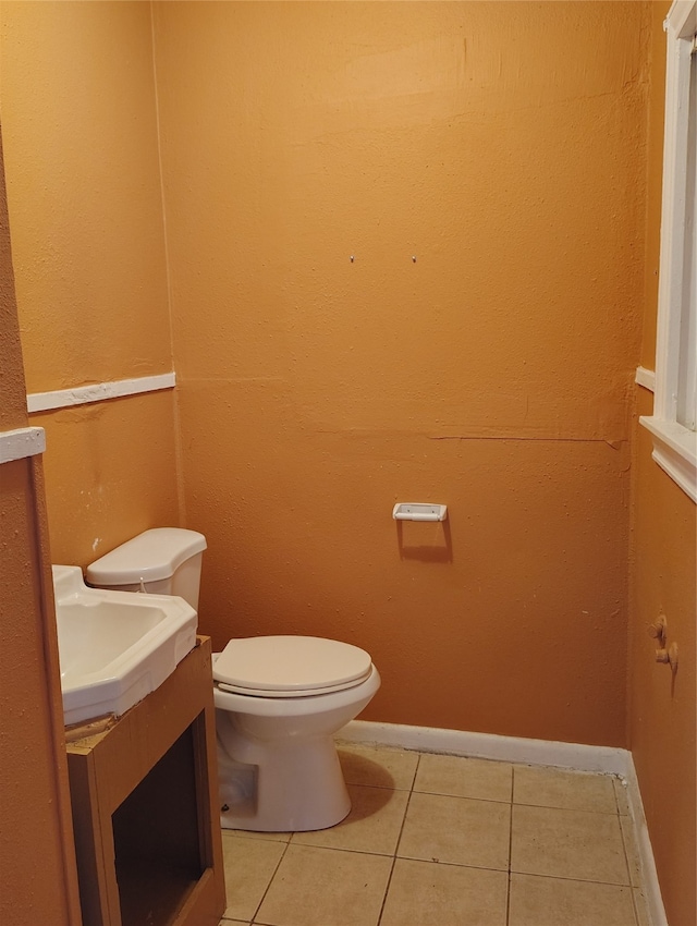 bathroom featuring tile patterned flooring, vanity, and toilet