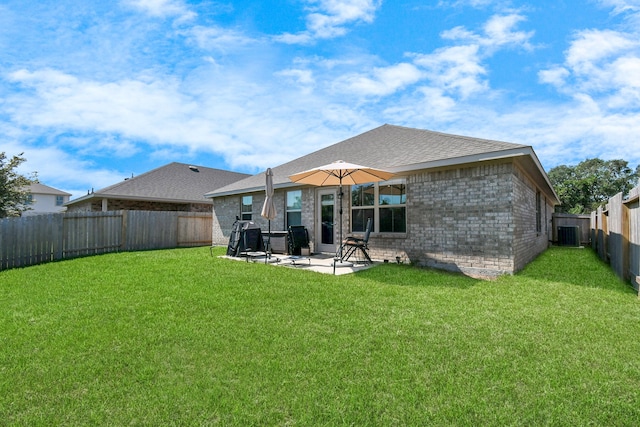 rear view of house with cooling unit, a patio area, and a lawn