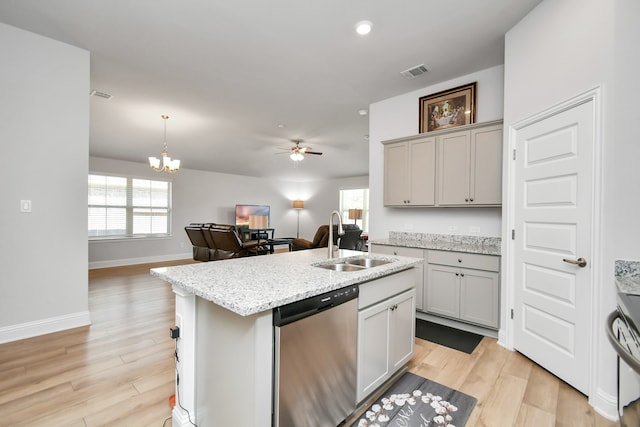 kitchen featuring pendant lighting, dishwasher, ceiling fan with notable chandelier, sink, and light hardwood / wood-style flooring