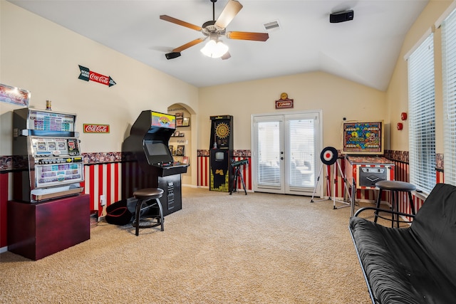 carpeted office space with ceiling fan, french doors, and vaulted ceiling