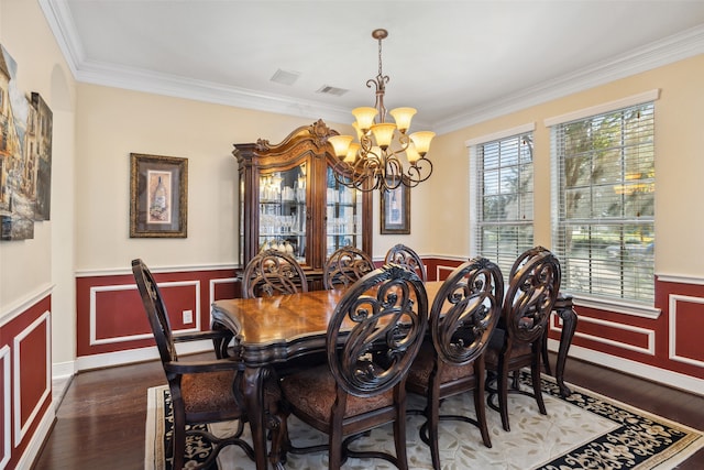 dining space featuring ornamental molding, dark hardwood / wood-style floors, and a notable chandelier