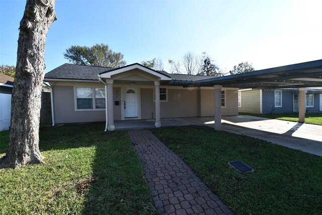 ranch-style house featuring a porch, a carport, and a front lawn