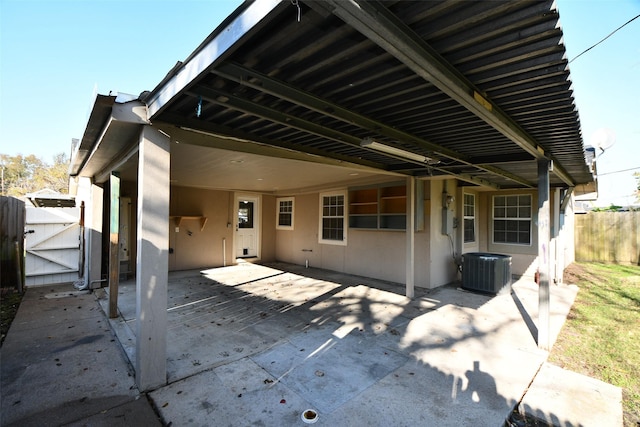 rear view of property with a patio area and central AC unit