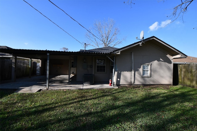 back of property featuring a lawn and a patio area