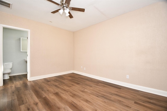 spare room featuring ceiling fan and dark hardwood / wood-style flooring