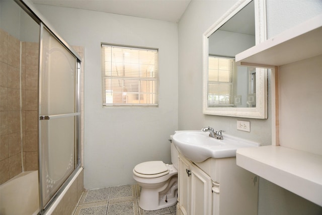 full bathroom with tile patterned floors, vanity, toilet, and enclosed tub / shower combo